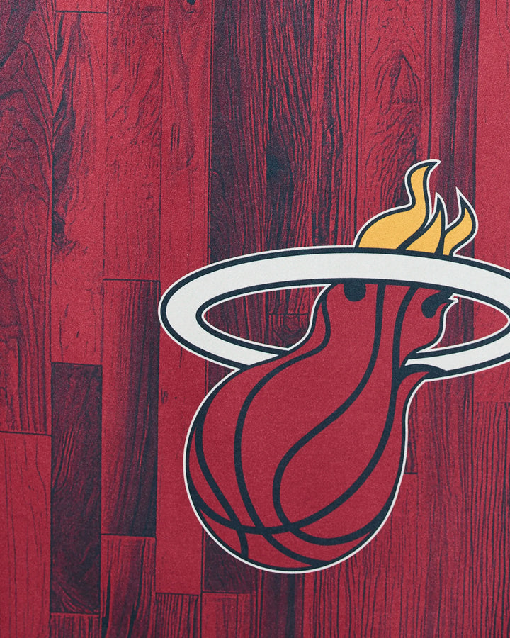 The Heat Zone towel by NBALAB x Geometry features the Miami Heat's flaming basketball logo passing through a white hoop on a red wood court background—perfect for any NBA fan.