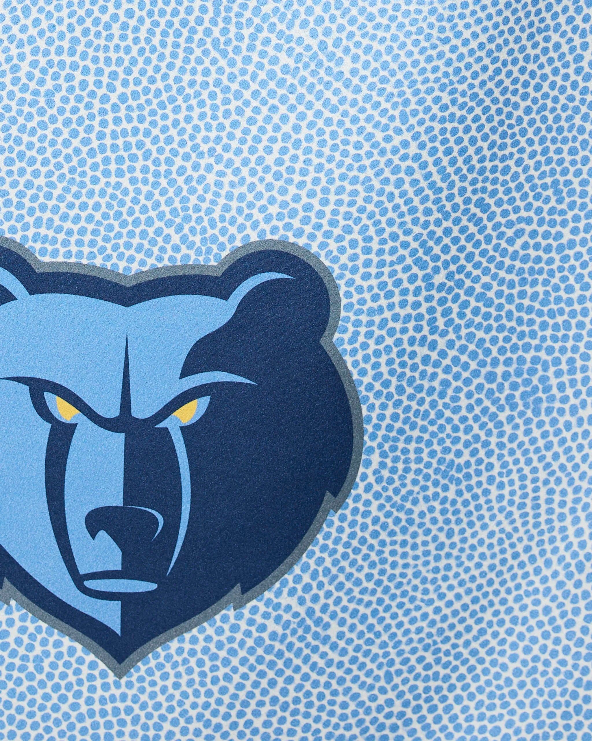 The Grizzlies Grip by Geometry features a bold, graphic blue bear head logo with yellow eyes on a dotted light blue background, showcasing sharp lines and striking contrasts.