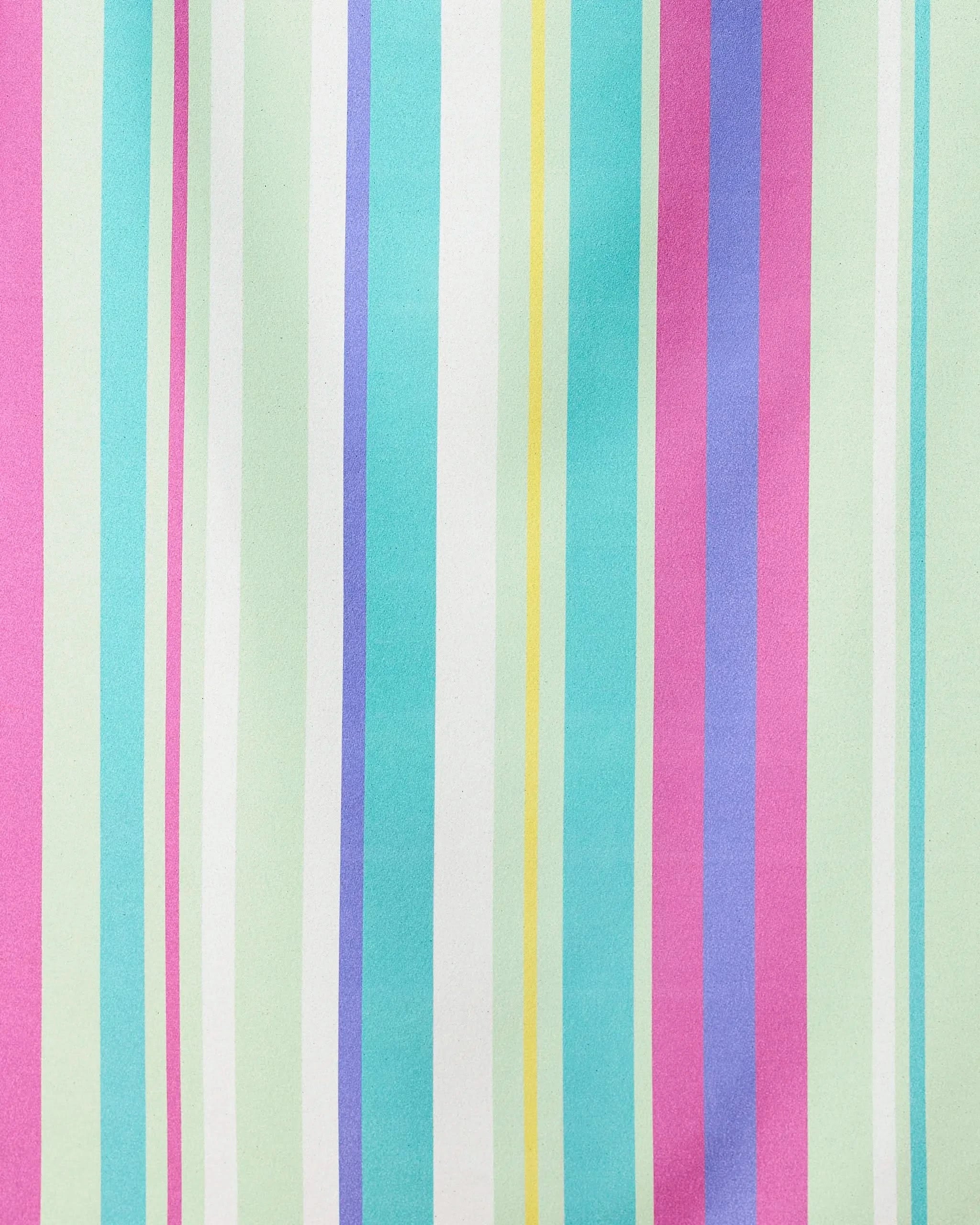 Pastel vertical stripes in pink, mint green, turquoise, yellow, white, and purple decorate the smooth Line It Up Grape Micro-loop Beach Towel by GEOMETRY, crafted from recycled materials.