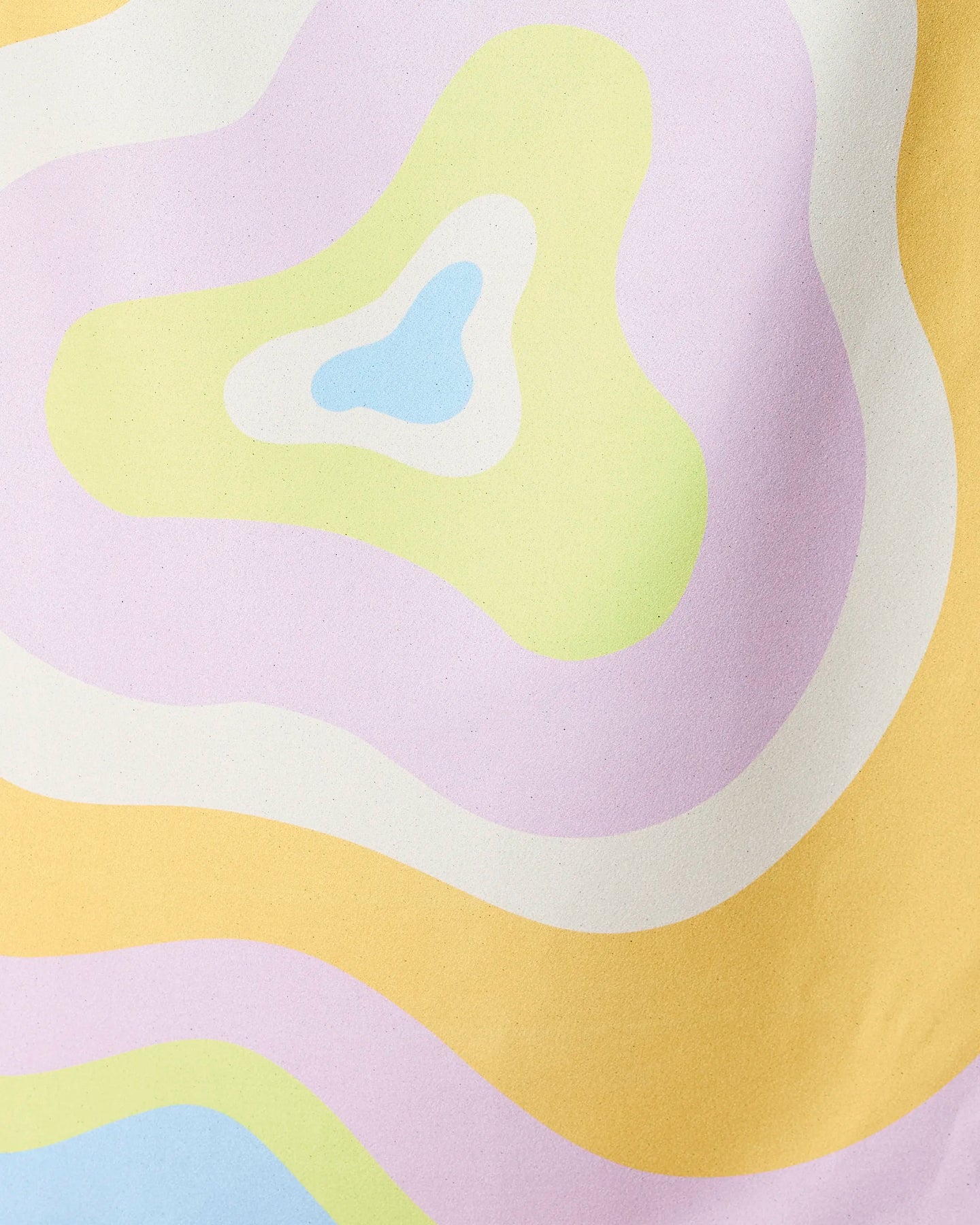 Pastel-hued, wavy shapes in yellow, lavender, green, blue, and white overlap in an abstract design—capturing the playful spirit of GEOMETRY’s Swirls Micro-loop Beach Towel.