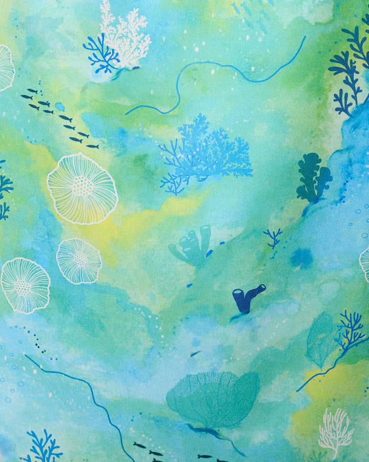 Watercolor-style illustration of vibrant corals, seaweed, and fish in blue-green hues—Reefy Greens by GEOMETRY is the perfect inspiration for a Micro-loop Beach Towel crafted from recycled materials.