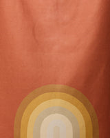 The Pumpkin Spice beach towel by GEOMETRY features an abstract design on a reddish-orange background with yellow, gold, and beige arcs—crafted from recycled materials for fast drying.