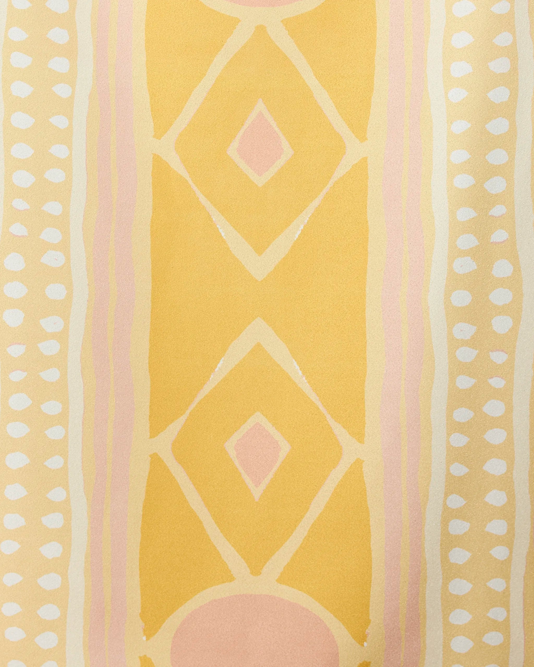The Beaded beach towel by GEOMETRY showcases yellow and pale pink diamonds, pink ovals, and vertical white dot rows on a light yellow background. Quick-drying with a soft, watercolor effect for stylish comfort.