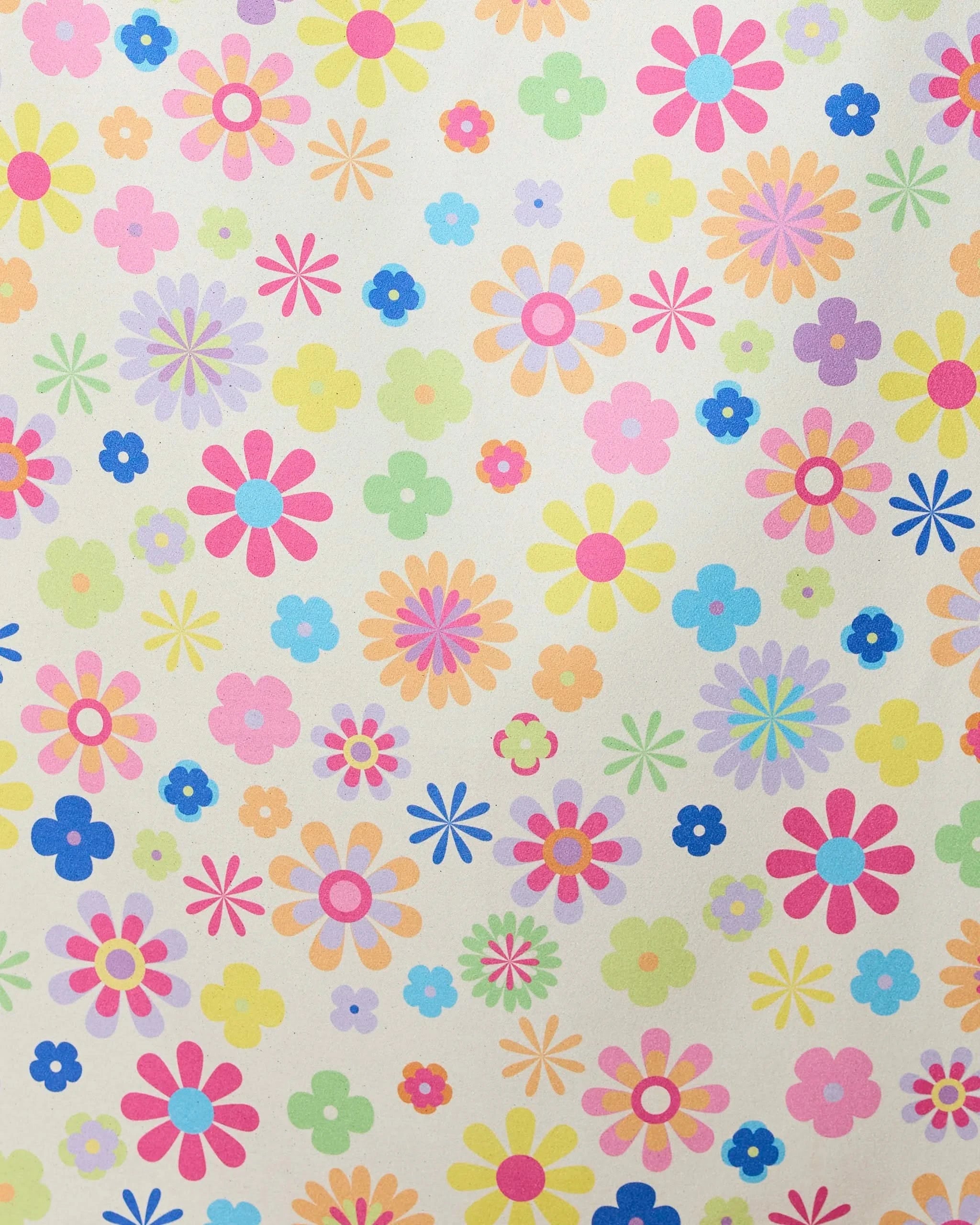 The GEOMETRY Far Out Flowers beach towel features a lively mix of overlapping, multicolored floral patterns on a light background and is made from quick-drying material.