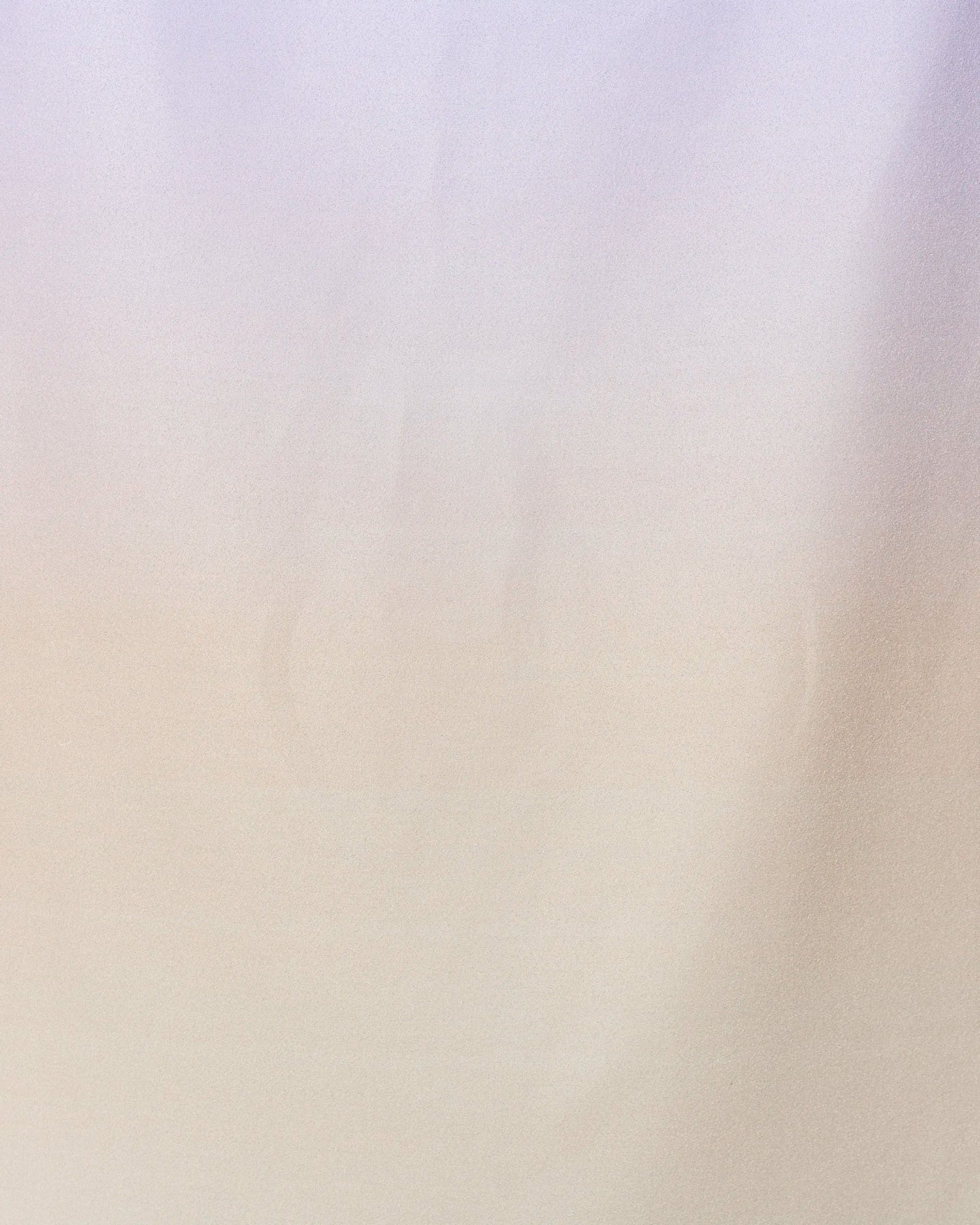 A soft, smooth fabric background with a subtle gradient of light beige and lavender, inspired by the calming look of GEOMETRYs Groovy Gradient Beach Towel made from recycled materials for a minimalist touch.