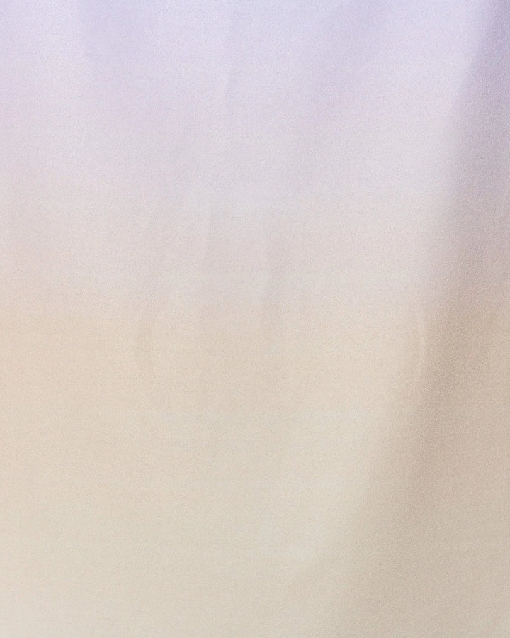 A soft, smooth fabric background with a subtle gradient of light beige and lavender, inspired by the calming look of GEOMETRYs Groovy Gradient Beach Towel made from recycled materials for a minimalist touch.