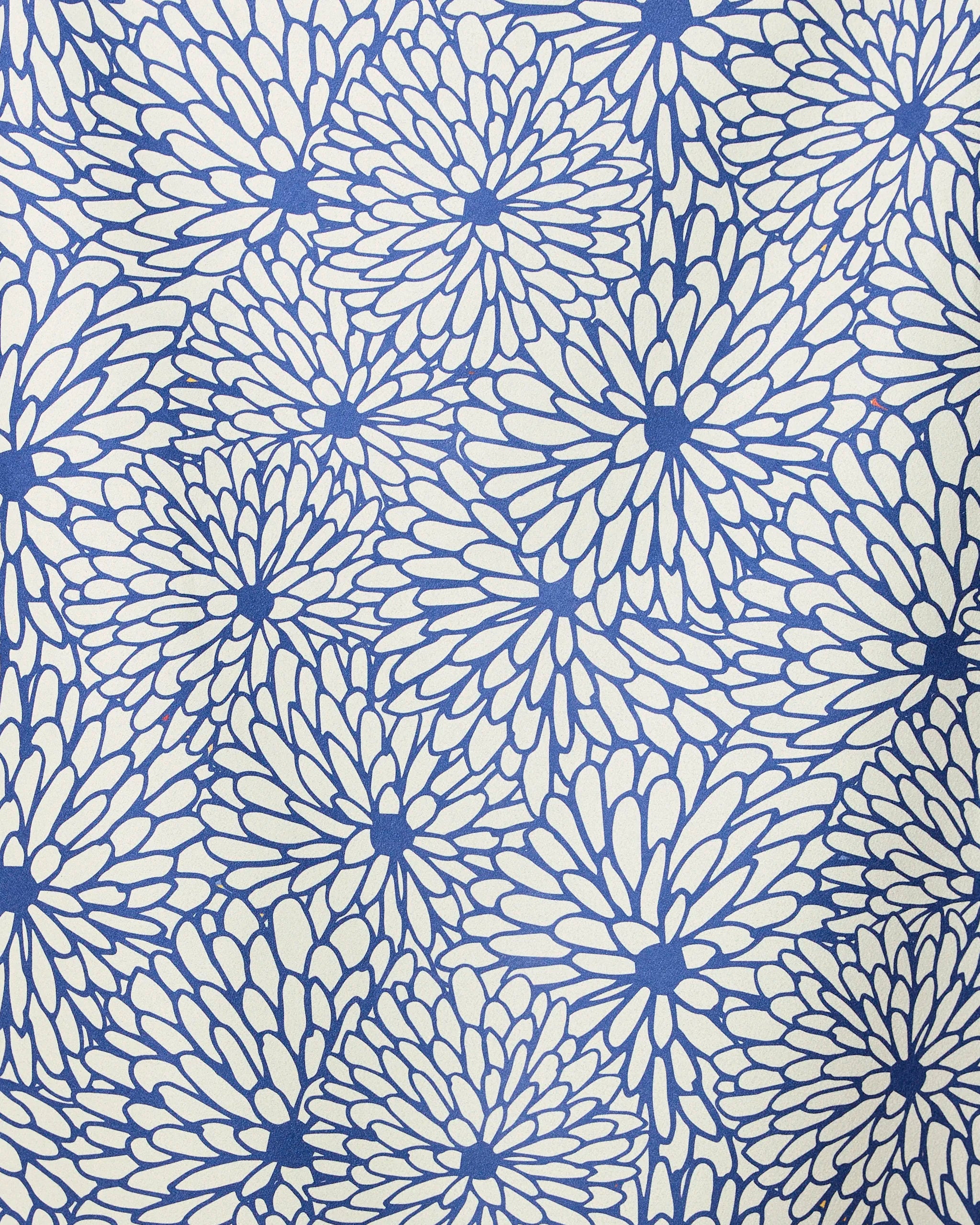 The GEOMETRY Jar Jar beach towel features dense blue flower-like patterns on a cream background, blending style and quick-drying function—ideal for stylish, practical days by the shore.