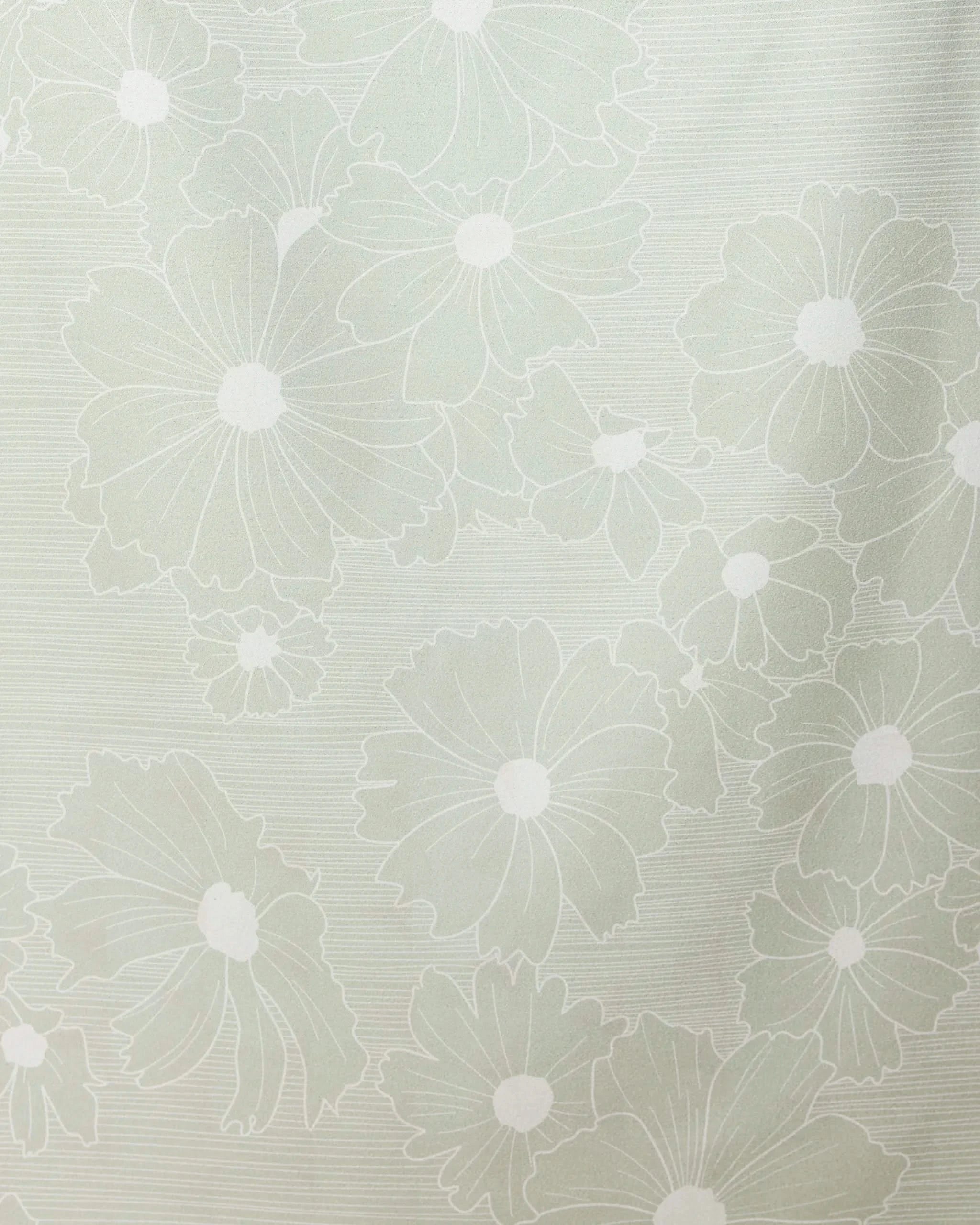 The Sage Petals Beach Towel by GEOMETRY features a light green design with large, white-outlined stylized flowers and leaves on a textured background. Made from recycled materials.