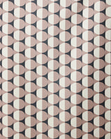 A retro, symmetrical design featuring repeating circles split into black and beige halves decorates the GEOMETRY Retro Round Light beach towel, crafted from recycled materials.