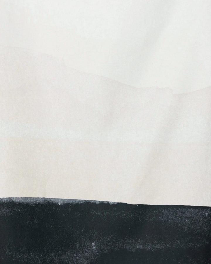 Top Layer by GEOMETRY features a black horizontal band at the base, fading to light gray and off-white above—creating a minimalist landscape with clean lines and subtle tones inspired by recycled materials.