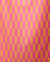 The GEOMETRY Bright Trapezoid micro-loop beach towel features a bold, repeating pink and orange trapezoid pattern for a vibrant 3D effect—both stylish and functional for your next beach outing.