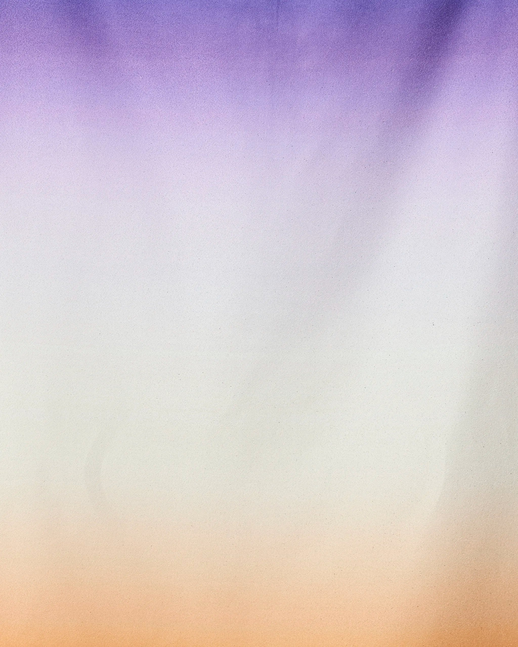 A soft gradient background transitions from purple to white to orange, evoking the Radiant quick-drying micro-loop beach towel by GEOMETRY, crafted from recycled materials with a smooth, calming color flow.