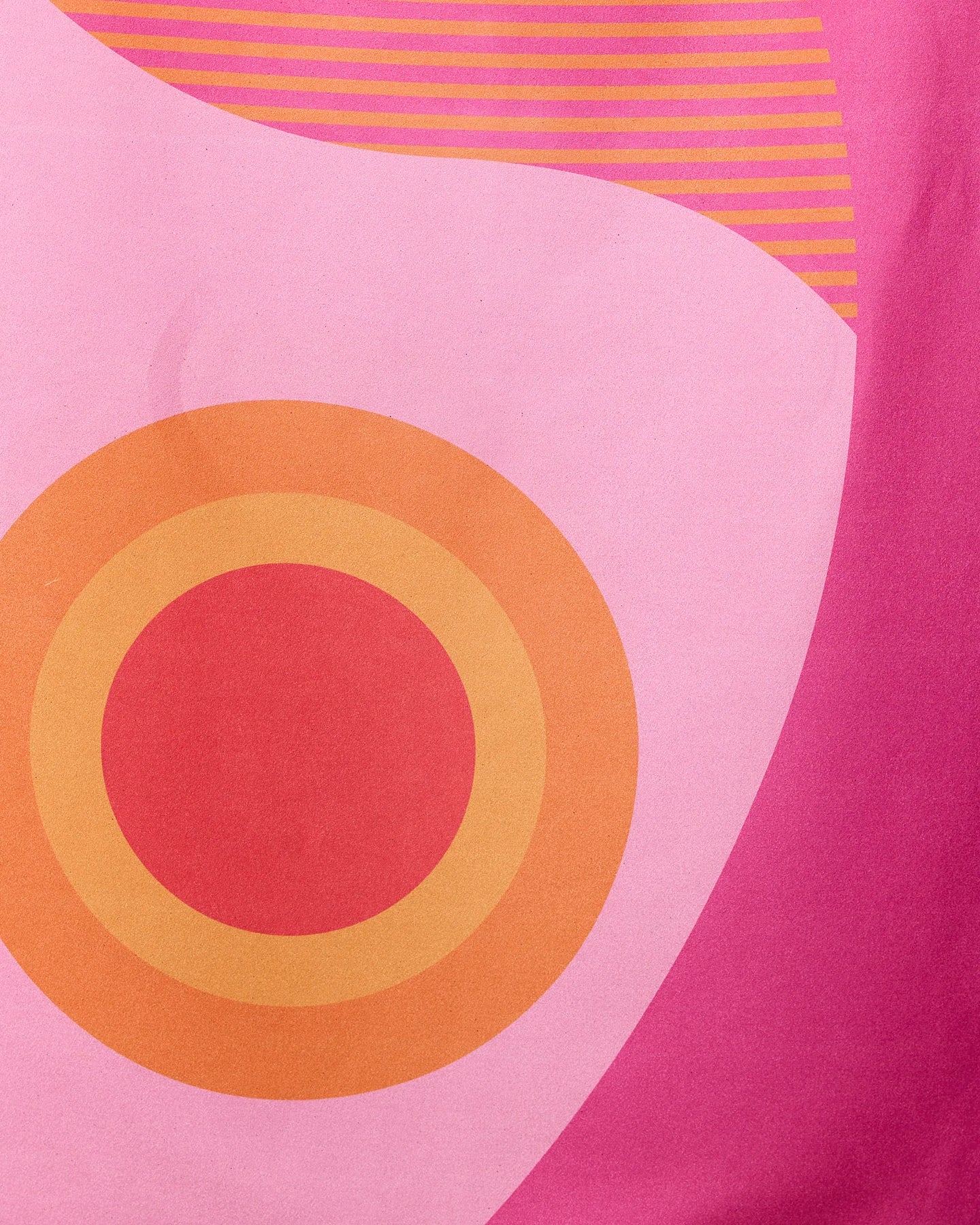 Abstract design with a large orange concentric circle on pink, curved shapes, and orange lines—perfect for the Round Trip Beach Towel by GEOMETRY, crafted from recycled materials.