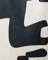 Abstract Neutral by GEOMETRY features a modern minimalist design of large, smooth-edged black and white shapes on a light background—ideal for the Geometry Micro-loop Beach Towel.