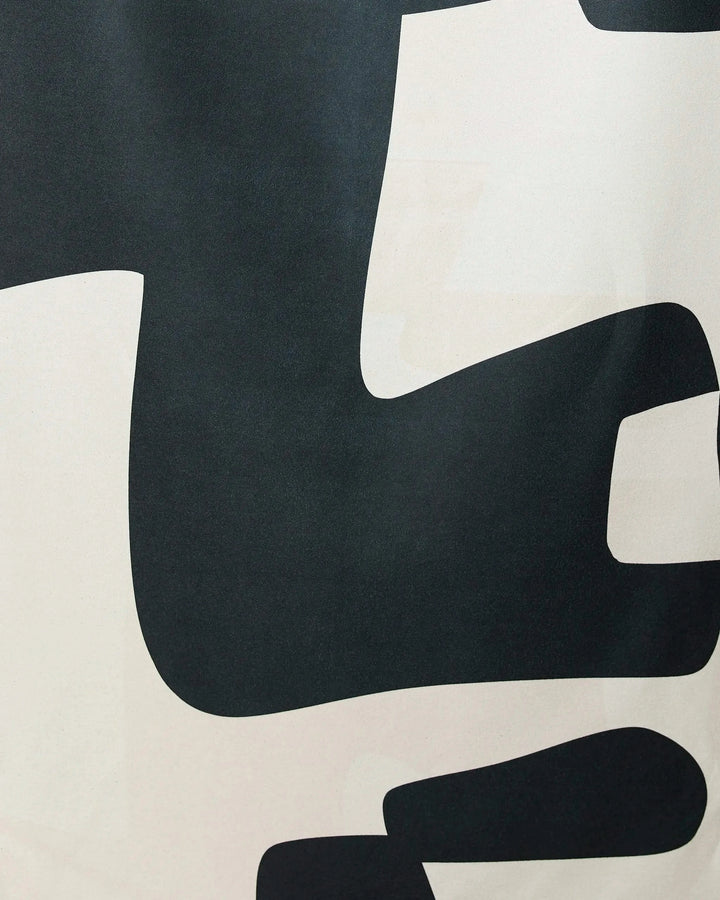 Abstract Neutral by GEOMETRY features a modern minimalist design of large, smooth-edged black and white shapes on a light background—ideal for the Geometry Micro-loop Beach Towel.