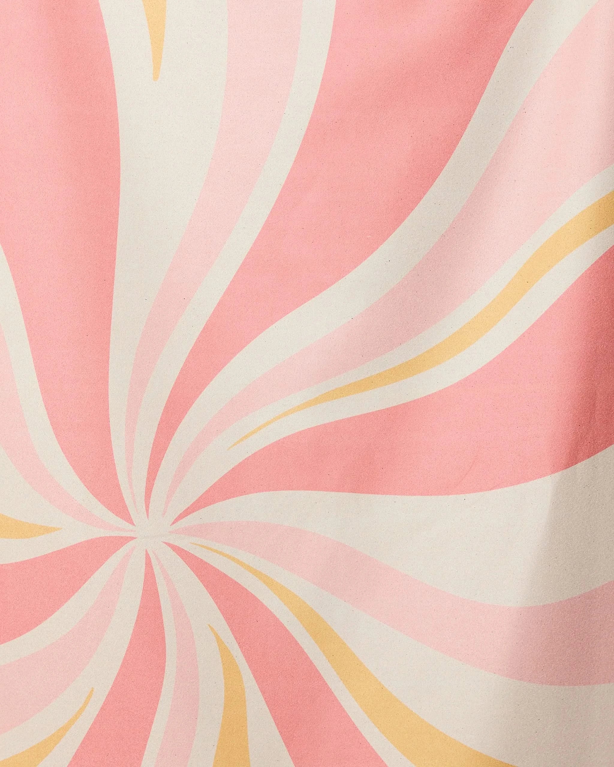 The GEOMETRY Candy Pink beach towel features a retro-inspired abstract pattern with swirling pink, cream, and light yellow lines radiating from the center. Its quick-drying fabric makes it perfect for stylish days by the water.