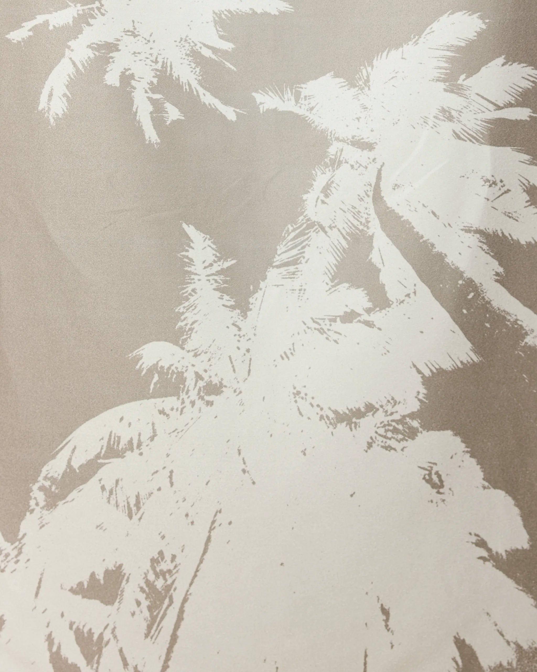 Beige-toned image featuring a white, stylized illustration of tall palm trees—like those on our GEOMETRY Sandy Palms towel—seen from below, with fronds spreading out toward the edges of the frame.