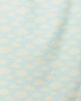 “Made In The Shade” by GEOMETRY features a light blue background with evenly spaced, fluffy white clouds—a whimsical pattern reminiscent of a cartoon sky. This quick-drying beach towel brings playful charm to your seaside days.