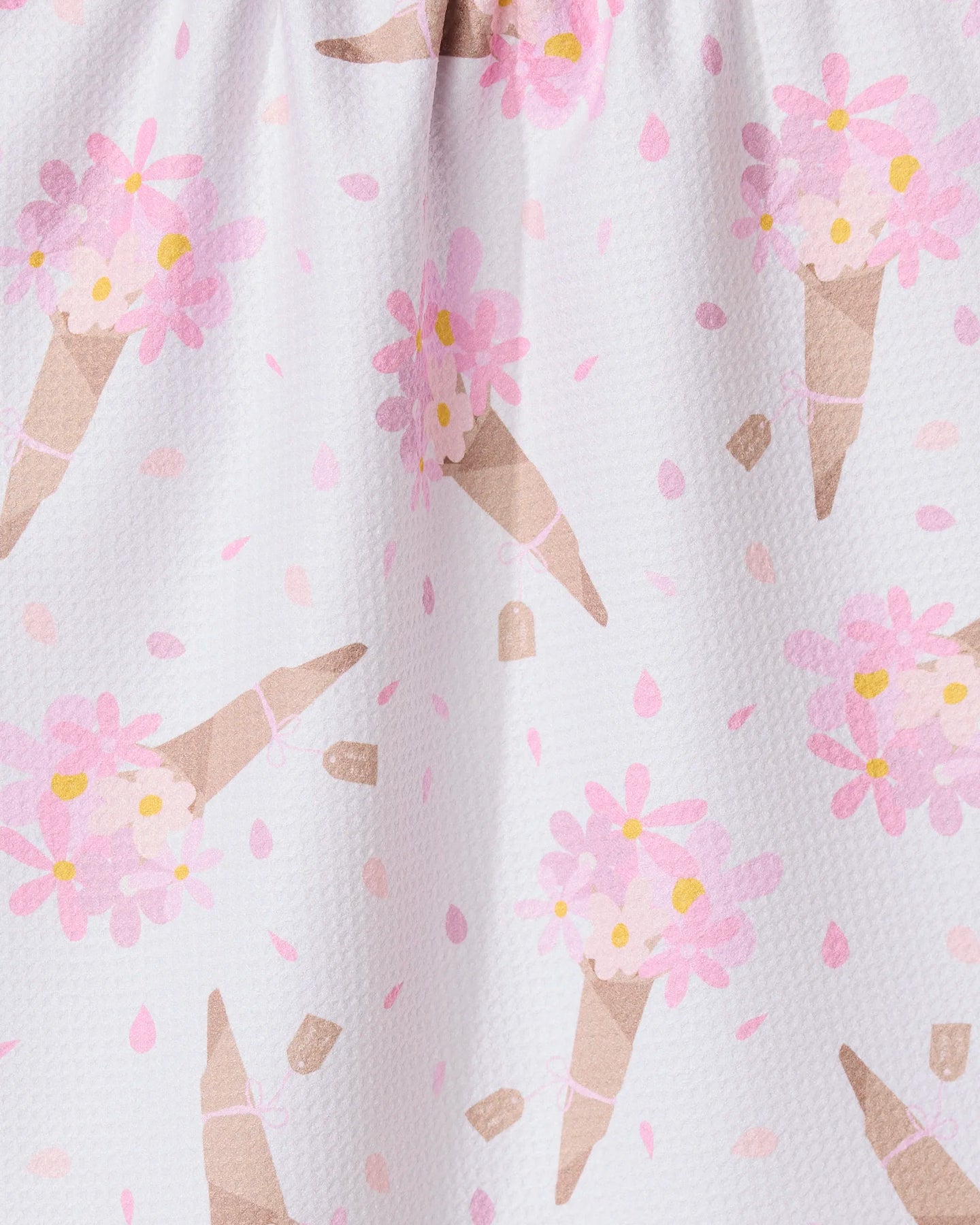 A close-up of the GEOMETRY Gorgeous Gift absorbent dish towel, showcasing a playful ice cream cone pattern with pink flowers and dots on a white background.