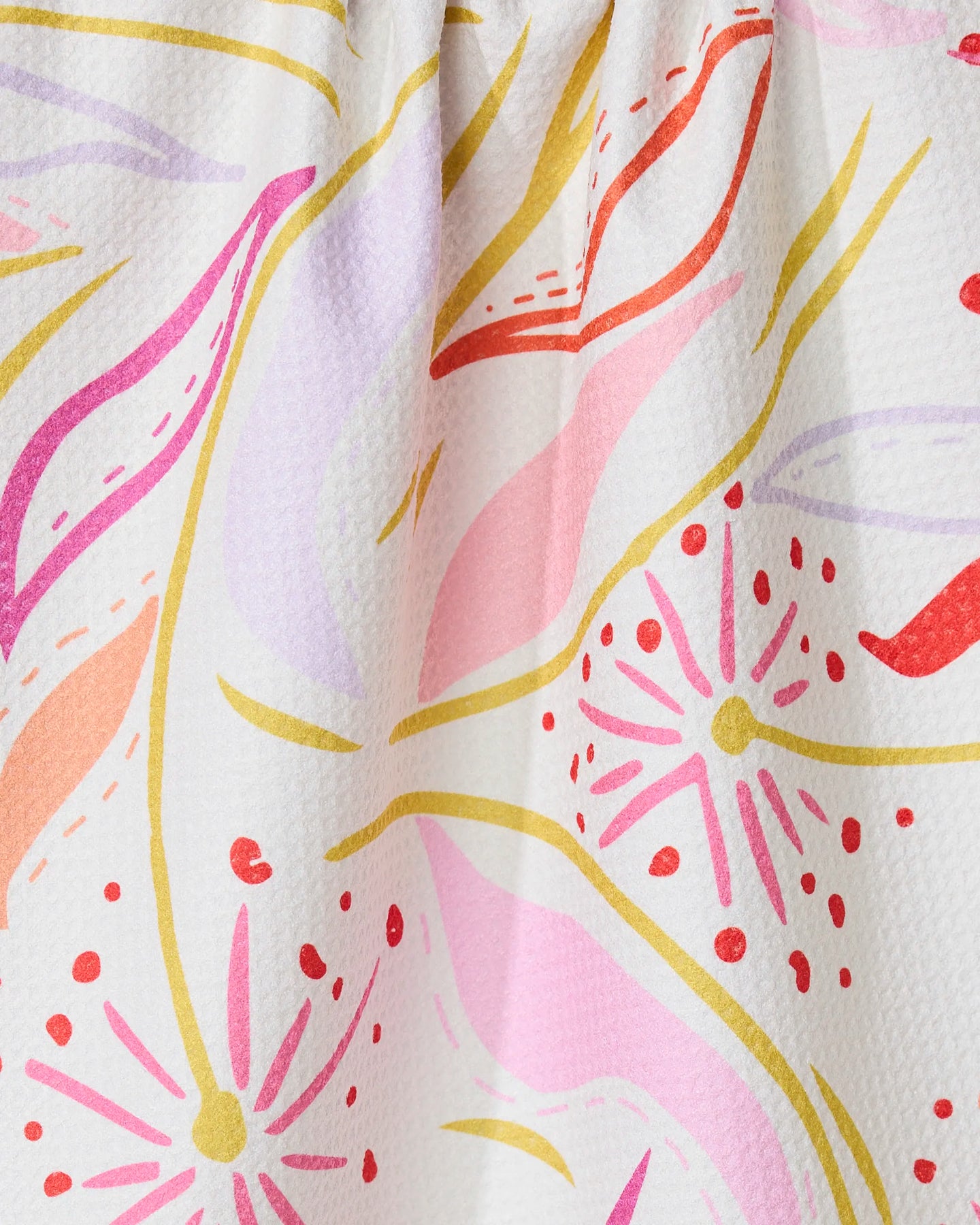 The GEOMETRY Grand Bloom kitchen towel features wavy lines and starbursts in pink, red, yellow, orange, and lavender on white. Made from recycled materials, it adds an eco-friendly touch to your kitchen.