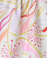 The GEOMETRY Grand Bloom kitchen towel features wavy lines and starbursts in pink, red, yellow, orange, and lavender on white. Made from recycled materials, it adds an eco-friendly touch to your kitchen.