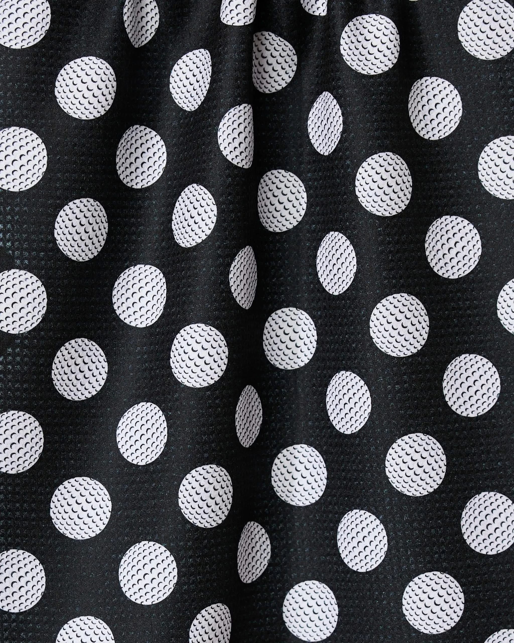 The GEOMETRY Hole In One towel showcases black fabric with white polka dots, visible texture, and subtle folds. Ultra-absorbent and stylish, it’s a practical addition to any kitchen.