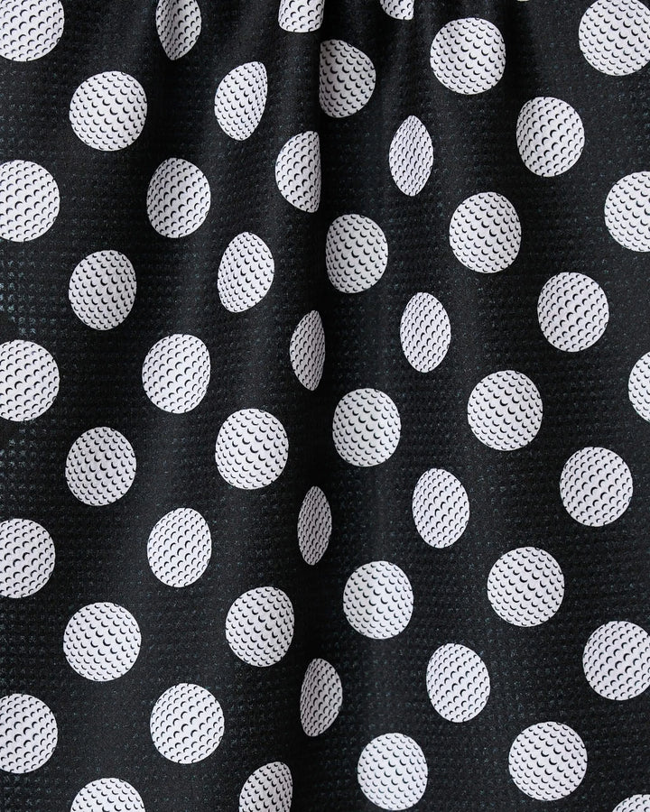 The GEOMETRY Hole In One towel showcases black fabric with white polka dots, visible texture, and subtle folds. Ultra-absorbent and stylish, it’s a practical addition to any kitchen.