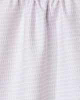 Close-up of Geometry’s Dot Dot Dot Blushed Bergamot kitchen towel, made from recycled fabric in light pink and white with a subtle grid-like dotted pattern. The gathered top creates soft folds and a textured look.