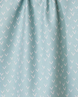 The Drawn Doves tea towel by GEOMETRY features a light blue color with small white check marks in diagonal rows, made from quick-drying fabric and gently gathered at the top.
