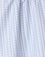 The GEOMETRY Fresh Linen tea towel features soft, gathered light blue and white stripes with a repeating pattern of small rectangles for a modern geometric look and textured feel, perfect for any kitchen.