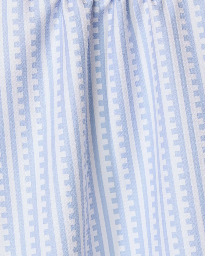 The GEOMETRY Fresh Linen tea towel features soft, gathered light blue and white stripes with a repeating pattern of small rectangles for a modern geometric look and textured feel, perfect for any kitchen.