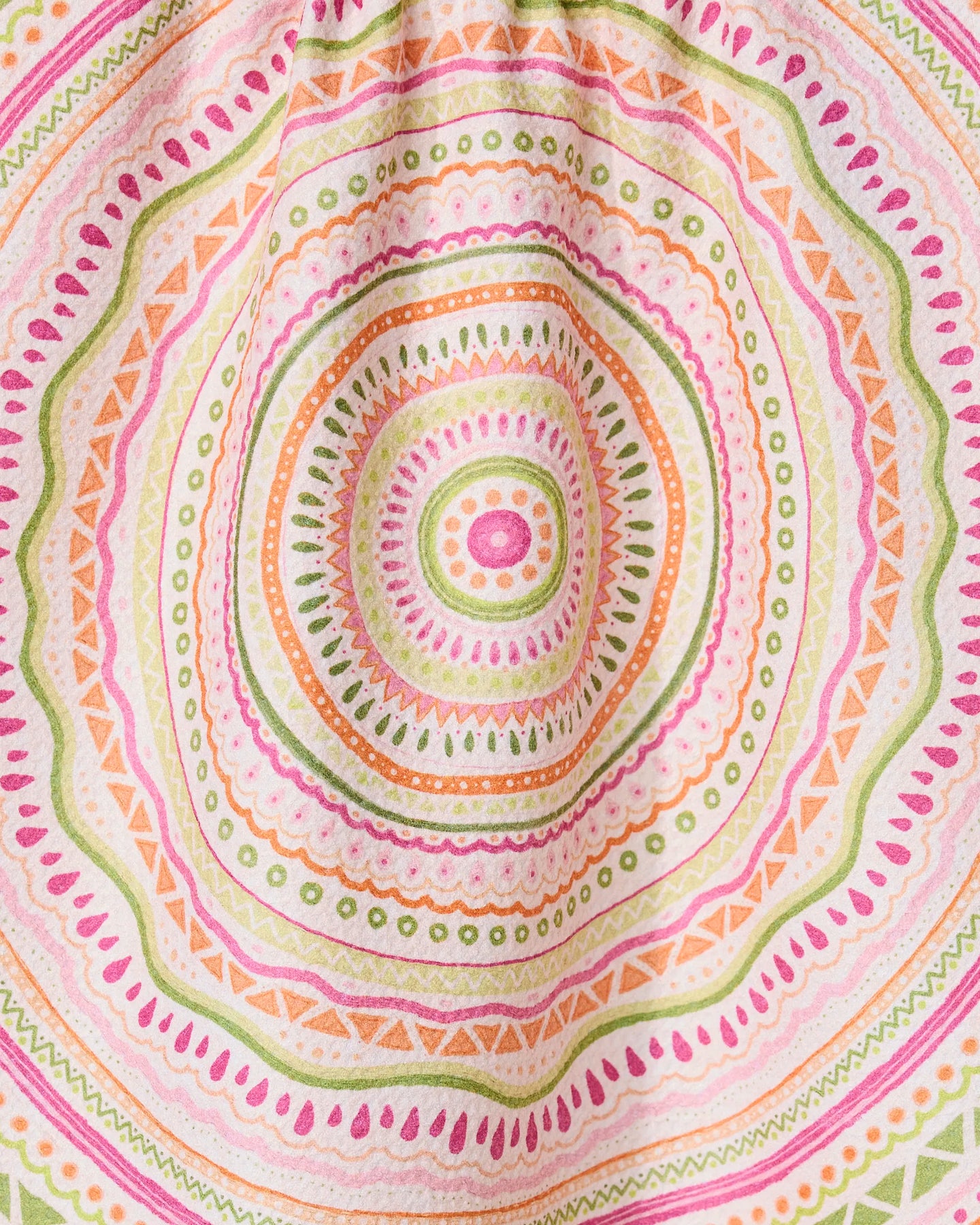 Bohemian Spring by GEOMETRY features a colorful mandala pattern with concentric circles and geometric shapes in pink, orange, green, and yellow on a quick-drying tea towel made from recycled materials.
