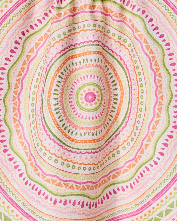 Bohemian Spring by GEOMETRY features a colorful mandala pattern with concentric circles and geometric shapes in pink, orange, green, and yellow on a quick-drying tea towel made from recycled materials.