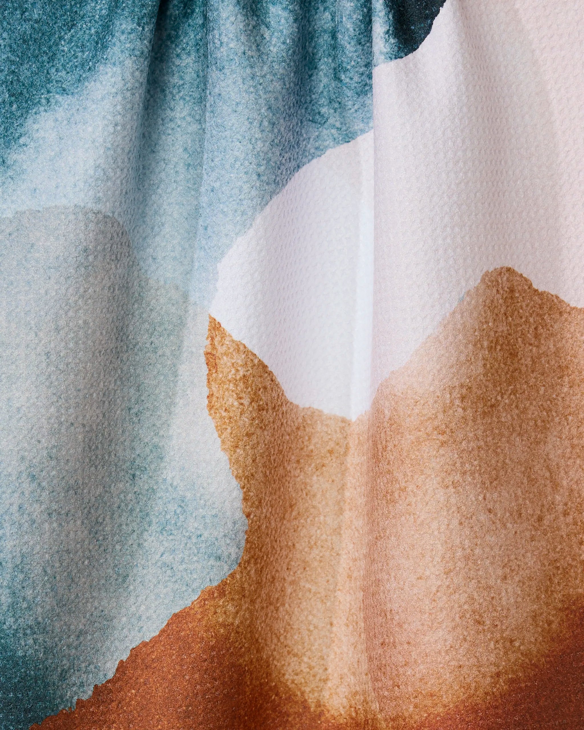 “Centered” by GEOMETRY features an abstract watercolor design in soft blue, white, and brown tones on a textured landscape—ideal for adding an artistic touch to a recycled tea towel.