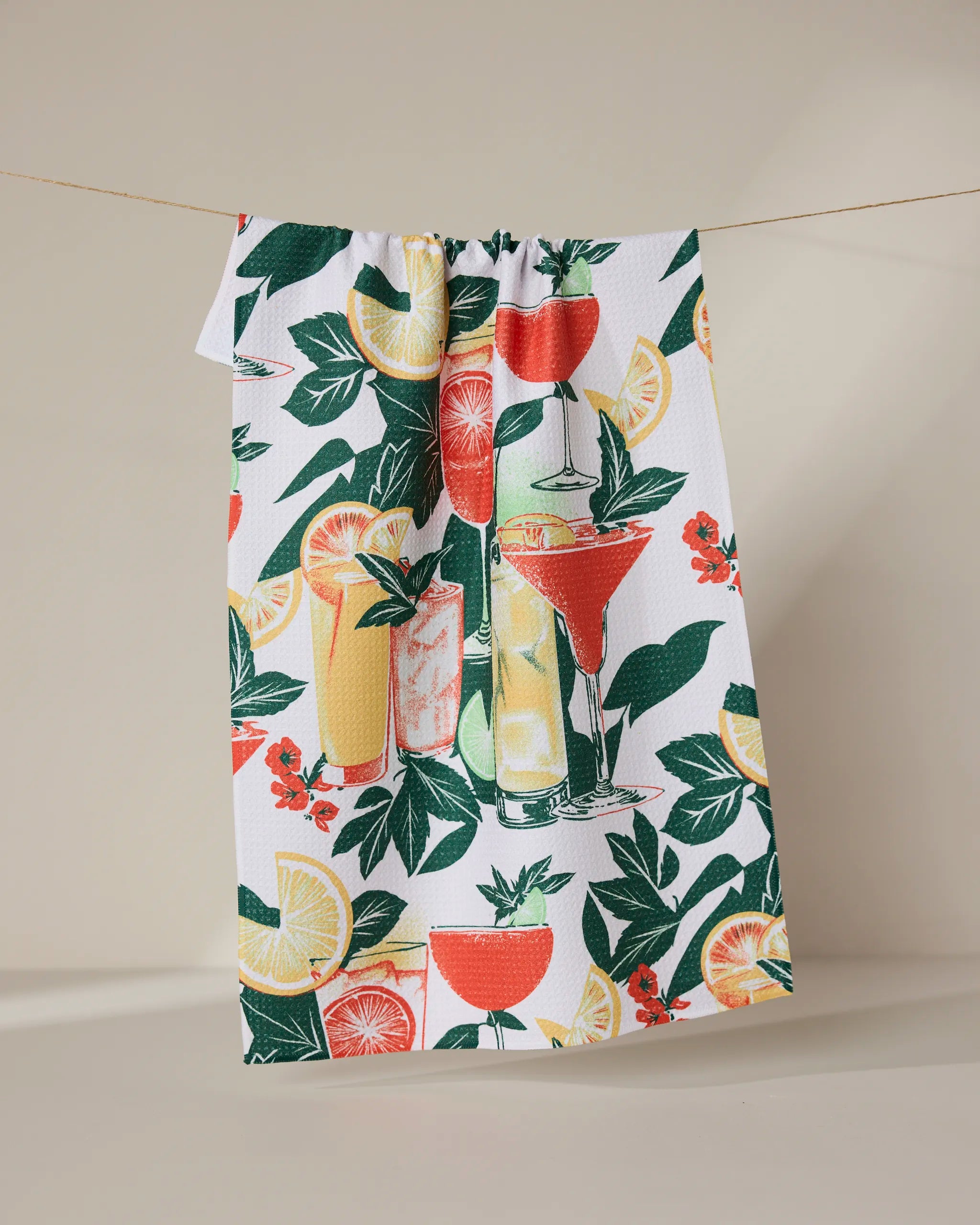 The Summer Refreshments recycled kitchen towel by Geometry features vibrant cocktails, citrus fruits, and green foliage on a white background for a colorful, eco-friendly touch.
