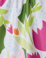 The GEOMETRY Paper Fields recycled kitchen towel features a colorful floral pattern with pink, green, and orange leaves plus blue raindrops on textured white fabric, adding cheerful charm to any space.
