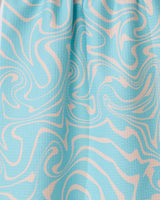 The Patience tea towel by GEOMETRY is light blue, crafted from recycled materials, and features a textured surface with abstract cream-colored wavy swirls in a marble-like design.