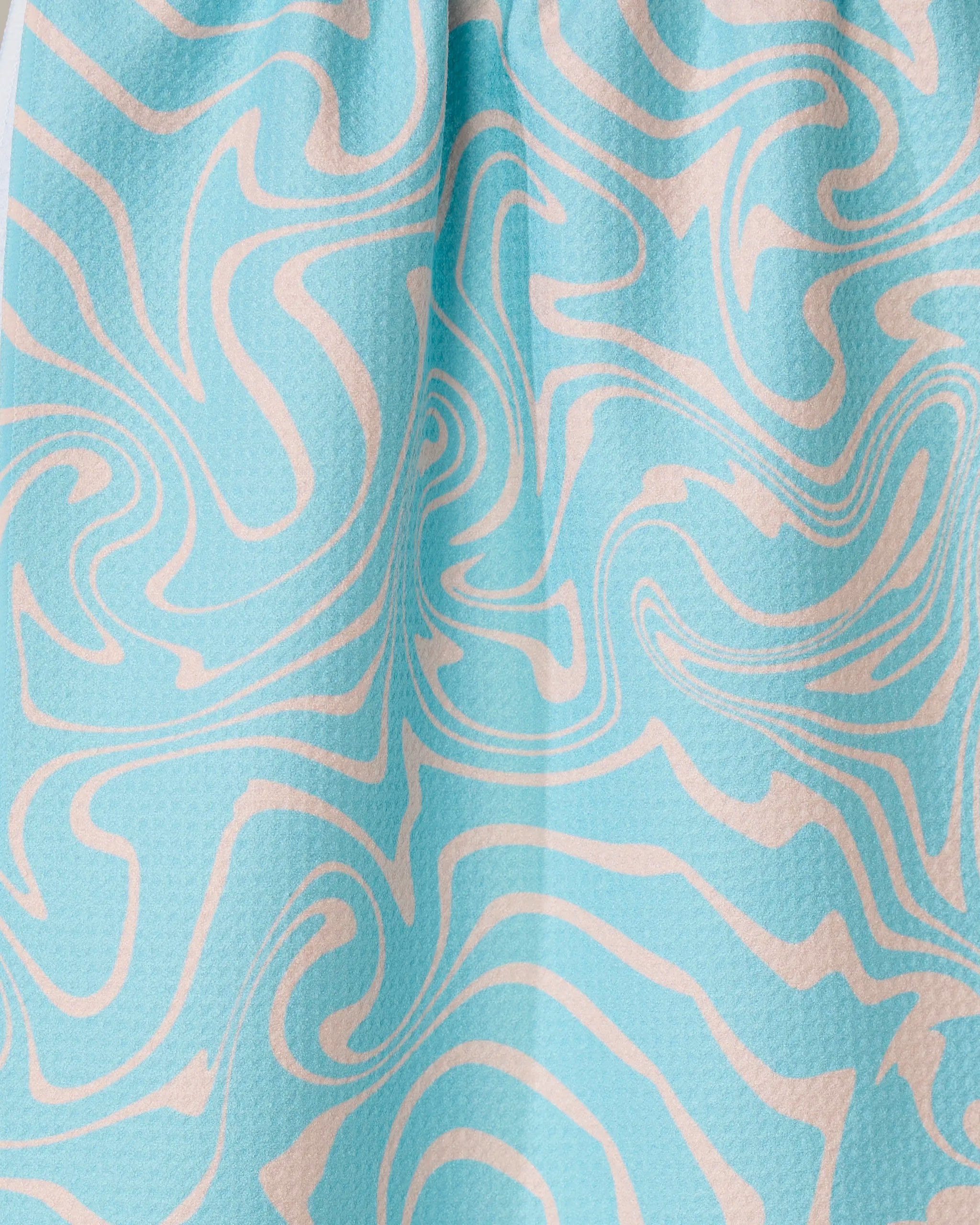The Patience tea towel by GEOMETRY is light blue, crafted from recycled materials, and features a textured surface with abstract cream-colored wavy swirls in a marble-like design.