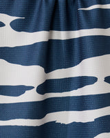 Close-up of the GEOMETRY Reflected - Midnight tea towel, made from recycled materials, with ultra-absorbency and a blue and white abstract wave-like striped pattern gathered at the top.