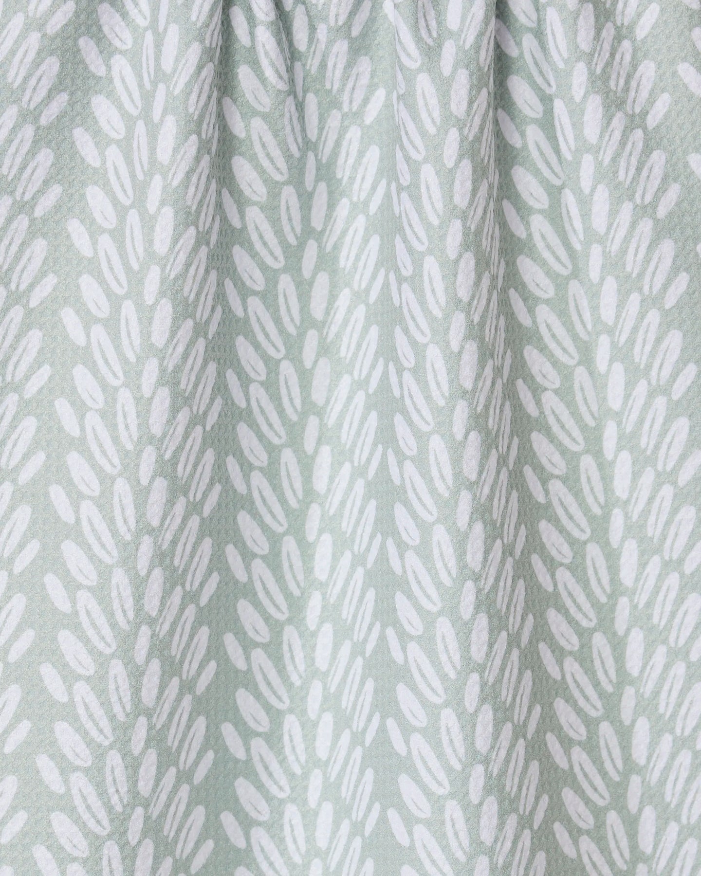 Seed by GEOMETRY features light gray fabric with white oval shapes in diagonal clusters. Slightly gathered at the top, its a stylish recycled kitchen or tea towel that adds both function and modern design to your space.