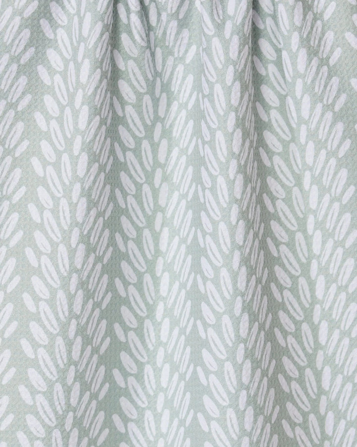 Seed by GEOMETRY features light gray fabric with white oval shapes in diagonal clusters. Slightly gathered at the top, its a stylish recycled kitchen or tea towel that adds both function and modern design to your space.