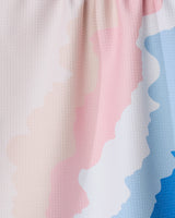 A close-up of the GEOMETRY Shore Tea Towel, crafted from Geoweave fabric with wavy pastel pink, cream, and blue patterns, showcasing its textured surface and soft folds.