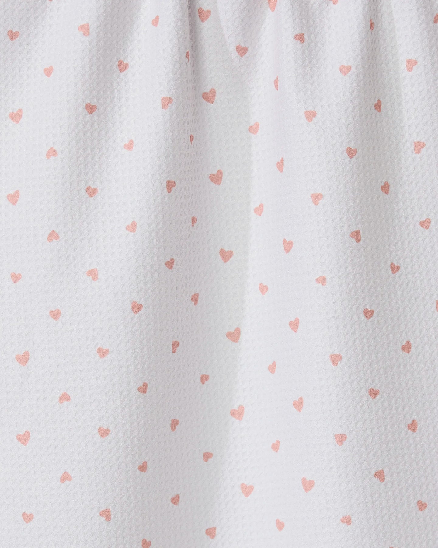 The GEOMETRY Tiny Hearts tea towel features ultra-absorbent white fabric with small pink heart patterns and a gathered top for soft folds and shadows.