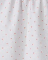The GEOMETRY Tiny Hearts tea towel features ultra-absorbent white fabric with small pink heart patterns and a gathered top for soft folds and shadows.