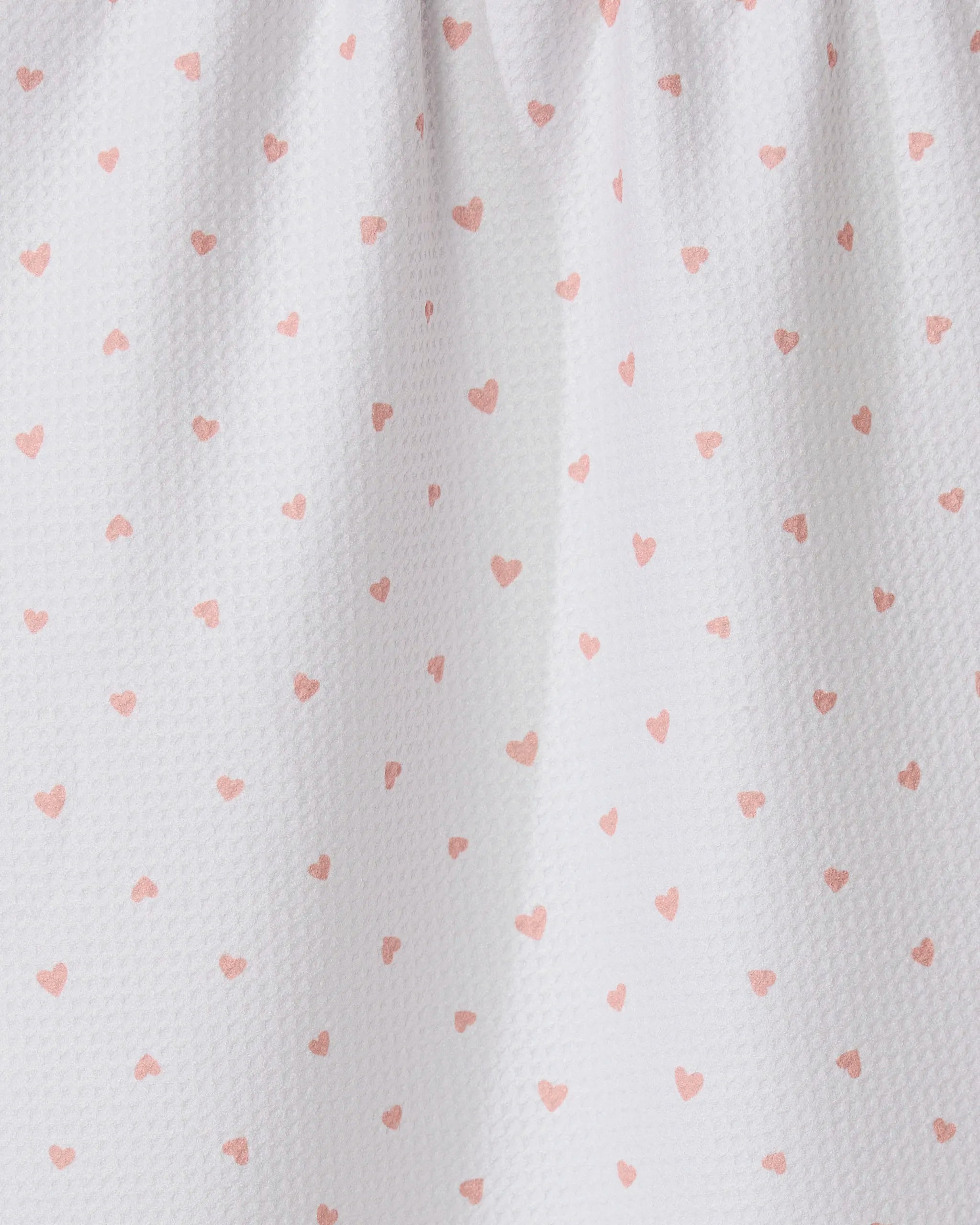 The GEOMETRY Tiny Hearts tea towel features ultra-absorbent white fabric with small pink heart patterns and a gathered top for soft folds and shadows.