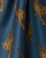 Leopard Lovin by Geometry is a quick-drying blue tea towel featuring golden-yellow leopards in walking poses—a stylish, practical addition to any kitchen.