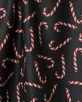 Geometry’s Sweet Canes tea towel features a black double-sided fabric with red and white striped candy canes in every direction, adding festive style and function to your kitchen.