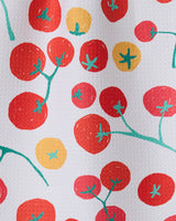 Ripe by GEOMETRY features red and yellow tomatoes with green stems on a textured white background, evoking a bar towel crafted from recycled materials. The varied sizes of the tomatoes add charm to this eco-friendly design.