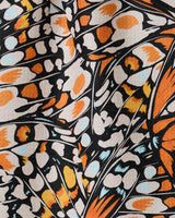 A close-up of GEOMETRY’s Wings in the Wind fabric, featuring butterflies and crafted from recycled materials.