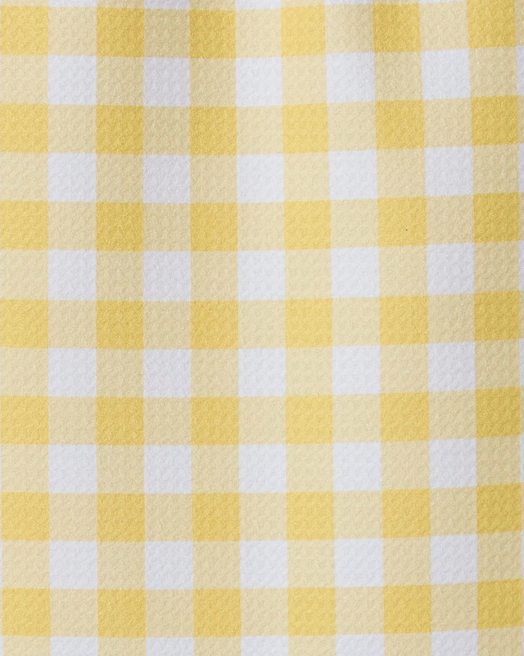 A close-up of GEOMETRY’s Lemon Gingham towel shows its yellow and white checkered pattern, featuring evenly spaced squares for a simple, classic, and ultra-absorbent design.